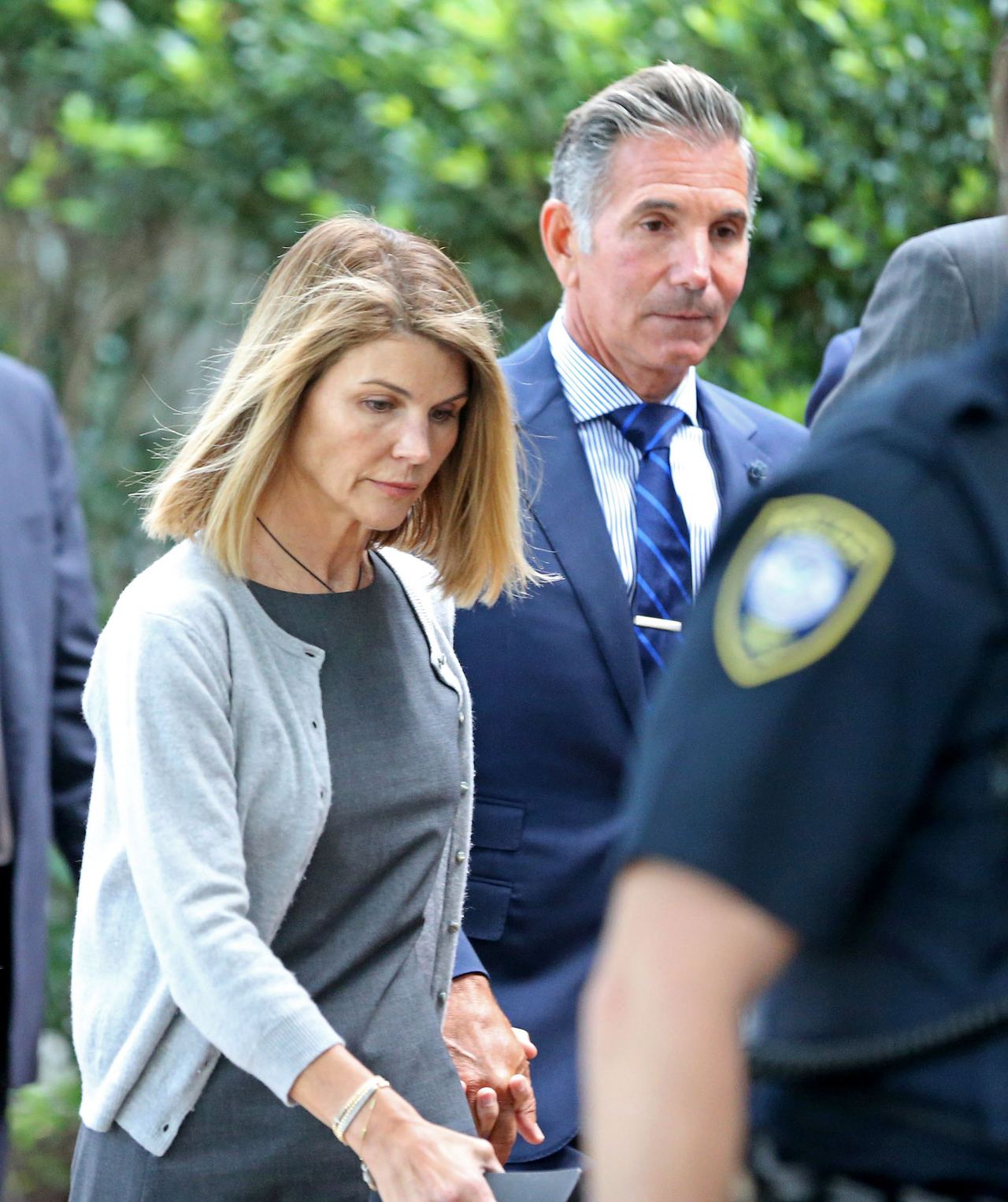 Lori Loughlin and her then-husband Mossimo Giannulli leaving Moakley Federal Courthouse after a brief hearing on August 27, 2019 in Boston | Source: Getty Images