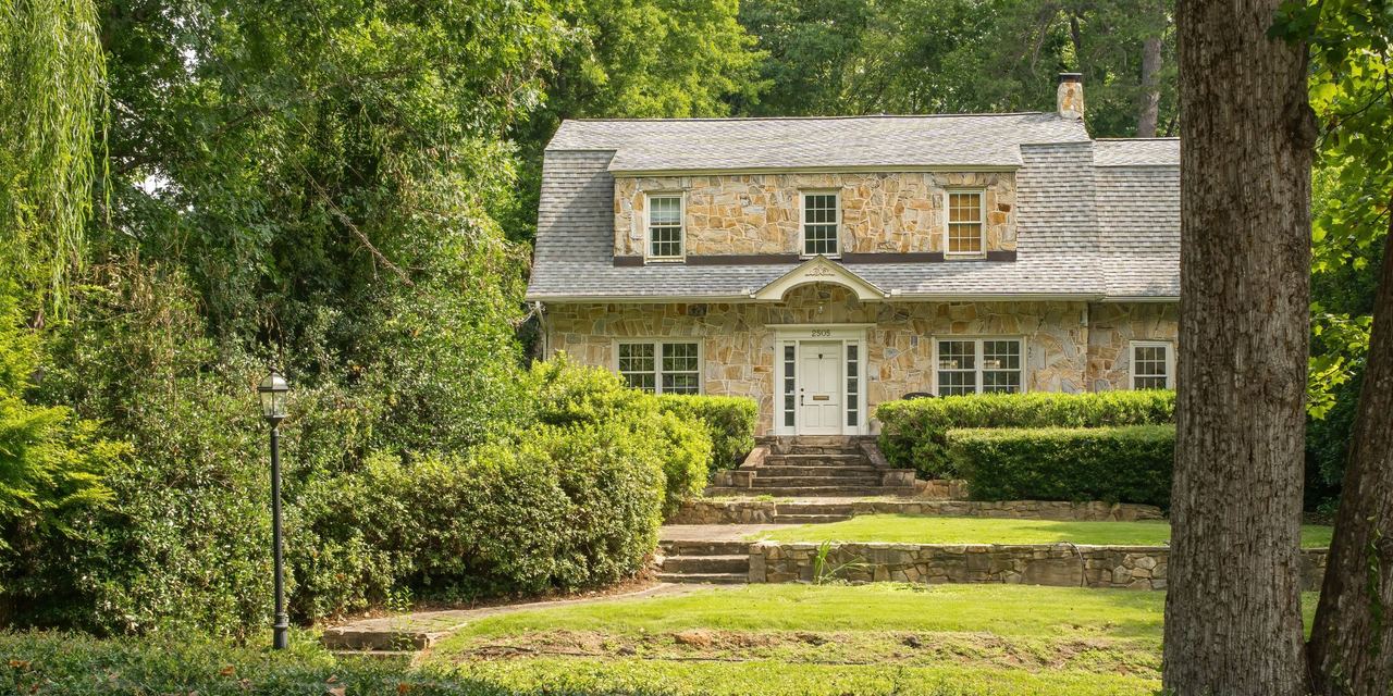 A stone mansion with beautiful landscaping | Source: Shutterstock