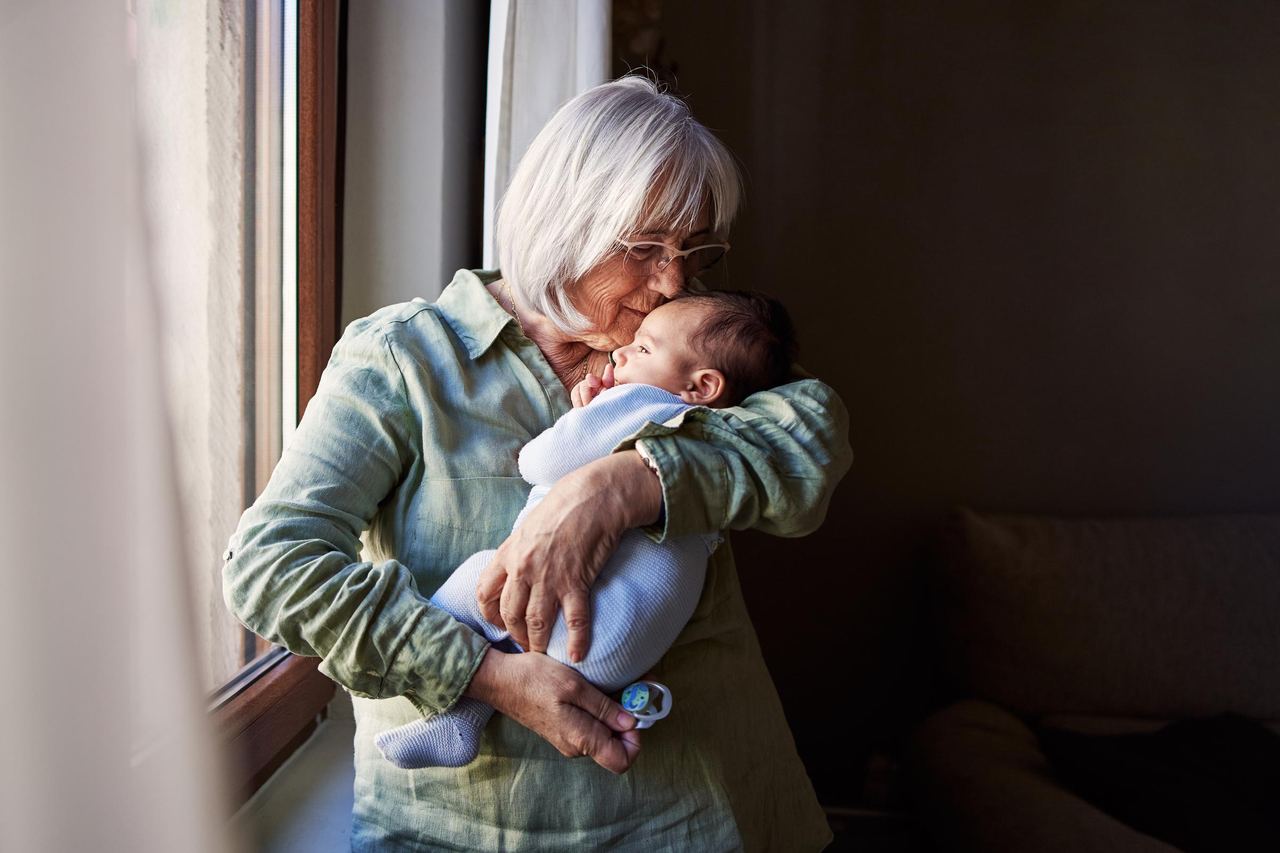 Grandma embracing a newborn baby | Source: Getty Images