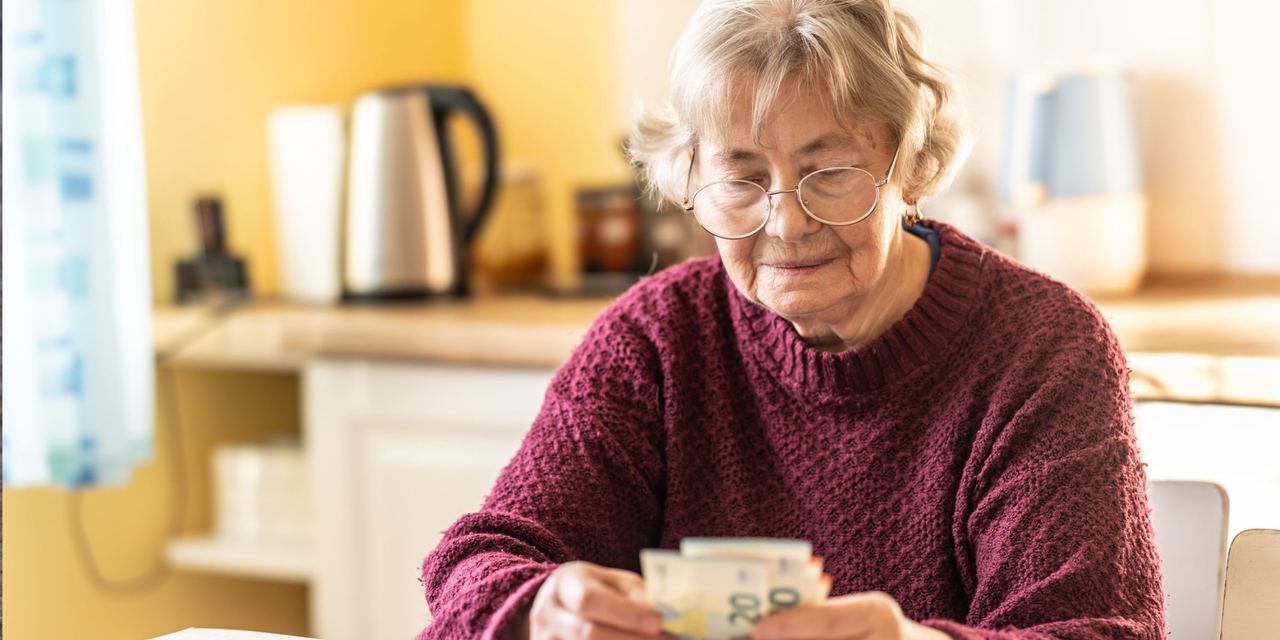 Close-up of a senior woman counting money in European Union currency | Source: Getty Images
