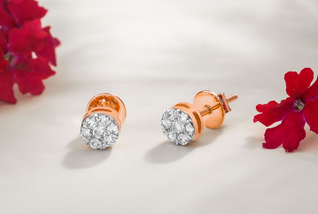 Close-up of diamond earrings with floral accents on white surface | Source: Pexels