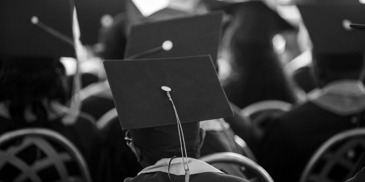 A black and white photo of students wearing graduation hats at a ceremony | Source: Pexels