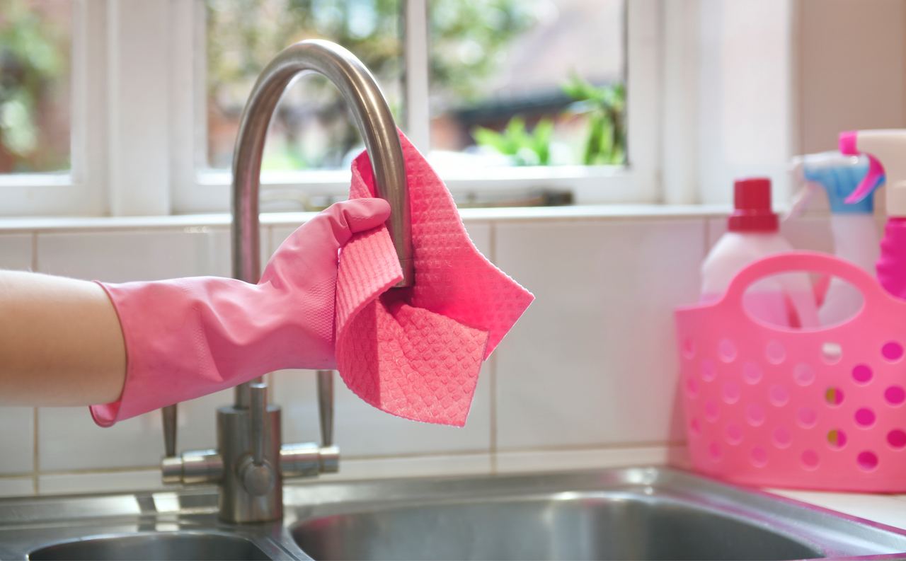 A person cleaning a kitchen surface | Source: Getty Images