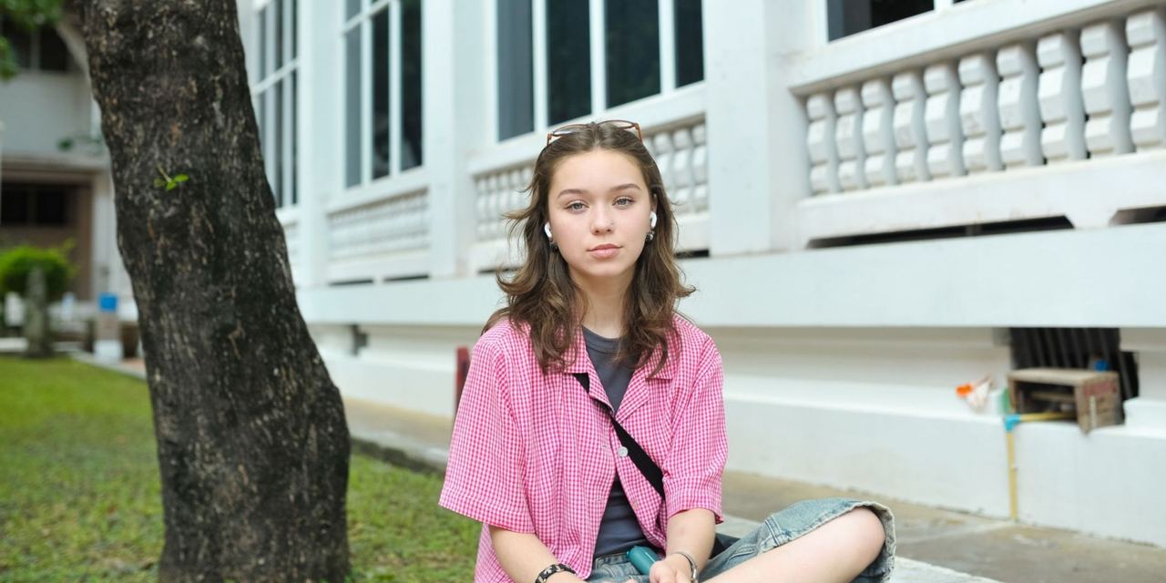 Teenage girl sitting outdoors near a building | Source: Pexels