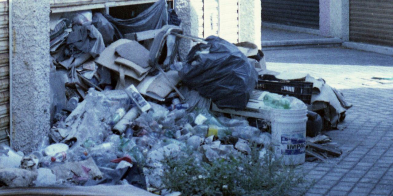 Abandoned garage with trash pile | Source: Pexels
