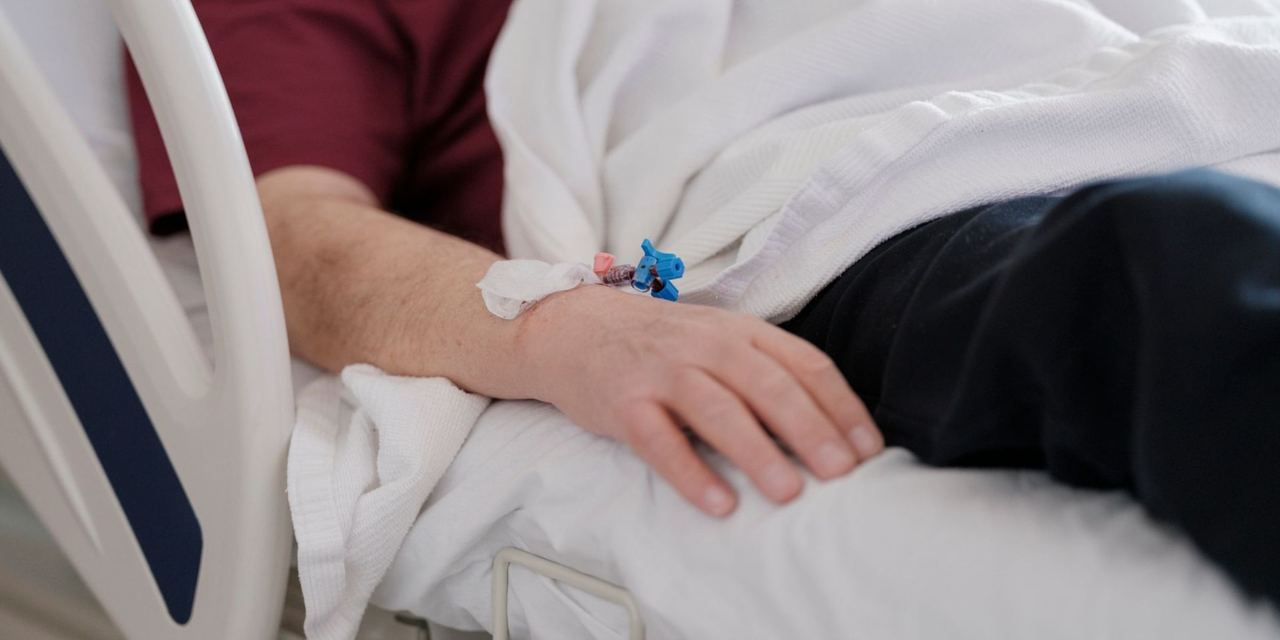 Patient resting in a hospital bed with an IV | Source: Pexels