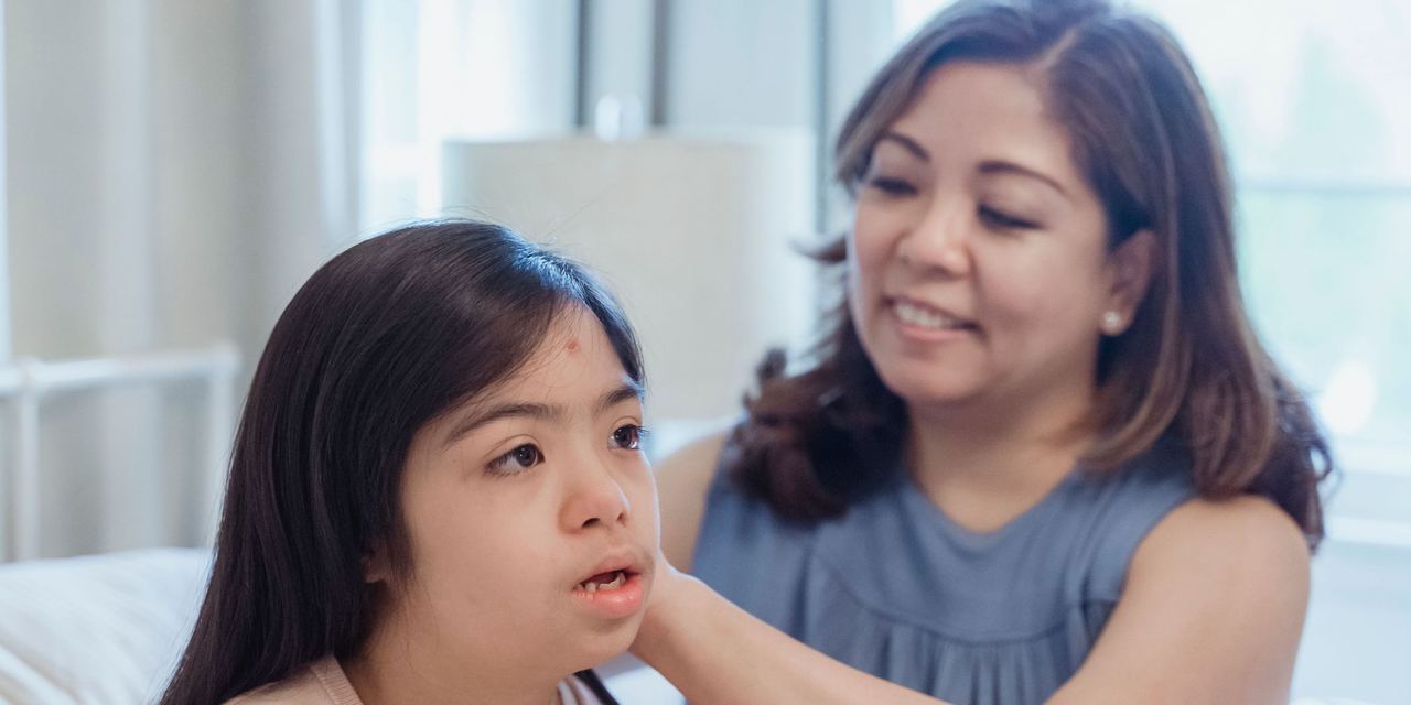 A woman bonding with a girl who has Down Syndrome | Source: Pexels