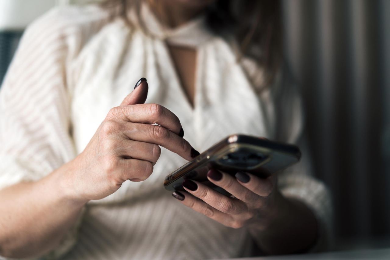 A woman using her phone | Source: Getty Images