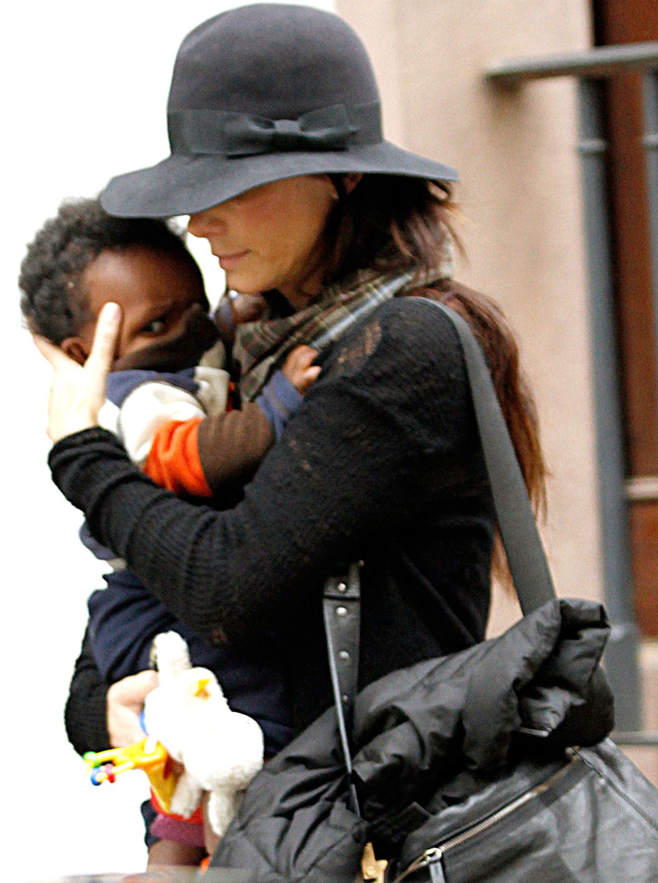 Sandra Bullock stepped out with her young son Louis Bardo Bullock in a rare public outing as she navigated life as a new mother under intense media scrutiny. During this outing, Bullock carried Louis while shielding his face from photographers on March 11, 2010, in Los Angeles, California. | Source: Getty Images
