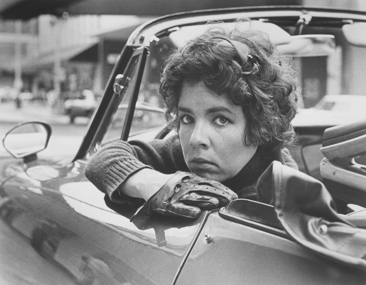 Stockard Channing sits behind the wheel of a convertible sports car in a scene from Dandy, the All-American Girl in 1976. The film came during the early stretch of her screen career, shortly after roles in The Hospital and Up the Sandbox and around the time of The Fortune, the film that was expected to establish her as a Hollywood leading lady. | Source: Getty Images