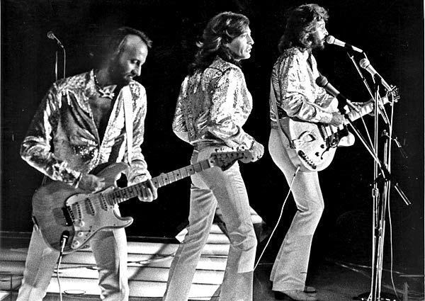 Maurice, Robin, and Barry Gibb performing together during the Bee Gees' late-1970s era. Archive image reproduced by The Roxborogh Report.