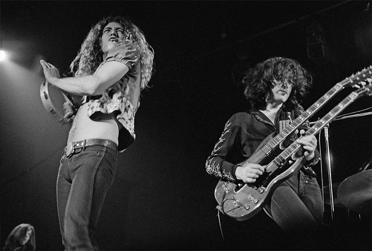 Robert Plant and Jimmy Page during Led Zeppelin's early-1970s concert era. Archive image reproduced by Planet Rock; illustrative, not a photograph of the Belfast performance.