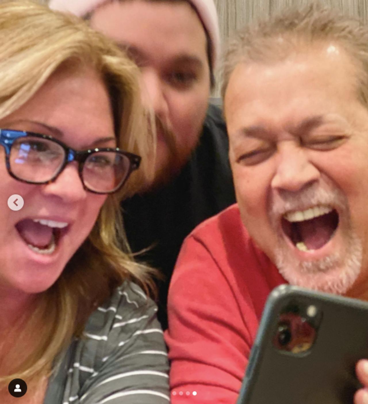Valerie Bertinelli, Wolfgang and Eddie Van Halen looking at something on a phone, posted on October 25, 2019 | Source: Instagram/wolfvanhalen