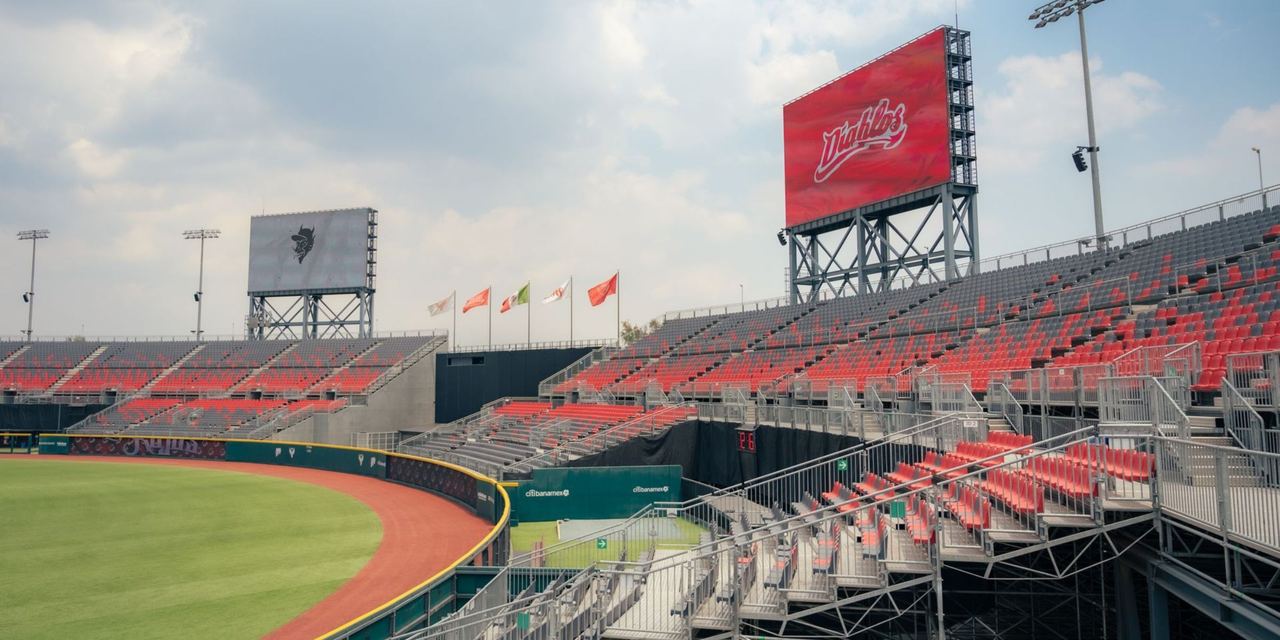 Empty stadium with red seats and a large scoreboard | Source: Pexels