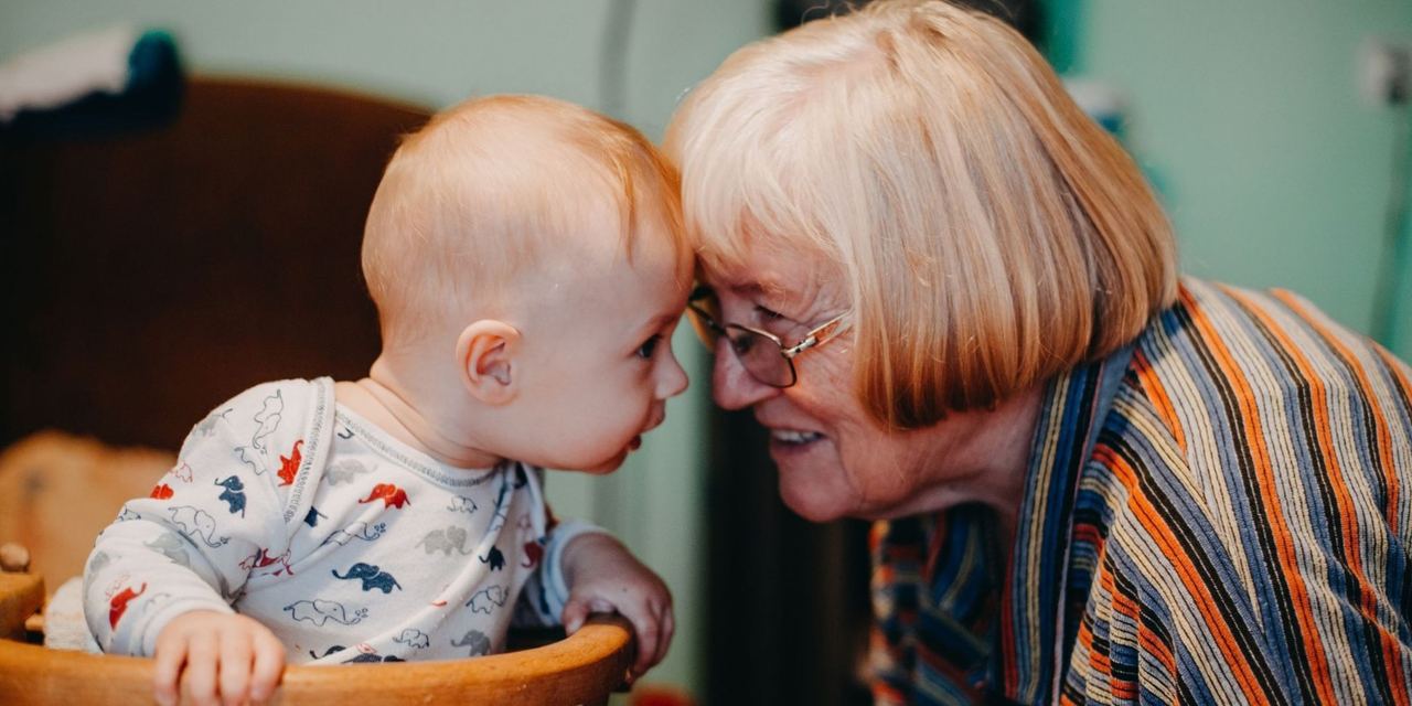 Grandmother sharing a tender moment with a baby | Source: Pexels