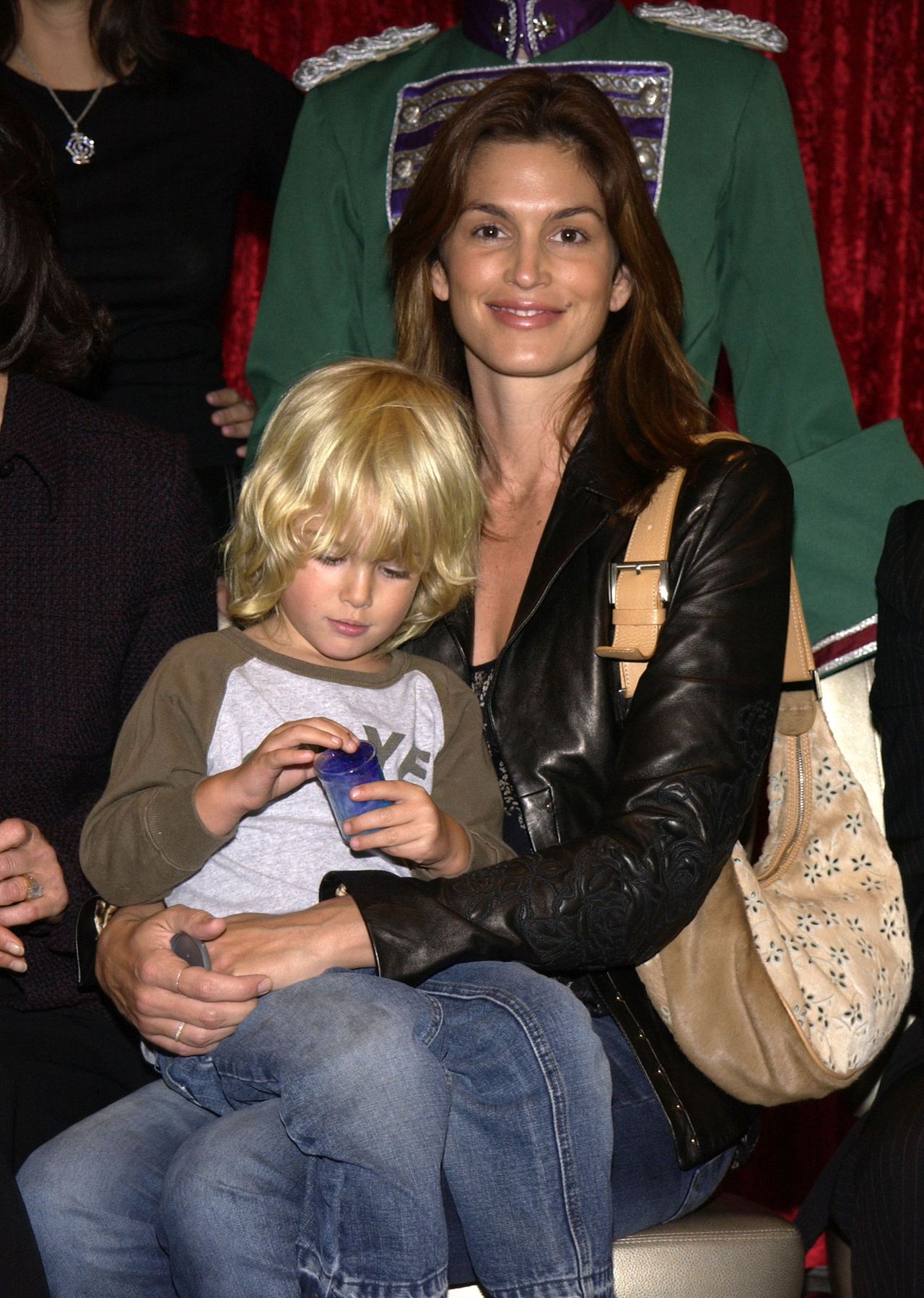 An archival photograph from December 2002 captures a much younger Presley Gerber sitting on his mother Cindy Crawford's lap, offering a glimpse of their early years together. The mother and son attended American Ballet Theatre's "The Nutcracker" Family Day Benefit in Hollywood. | Source: Getty Images