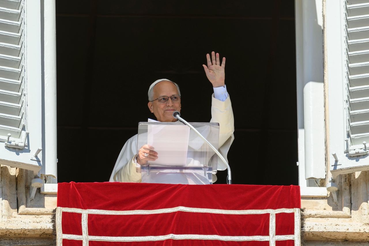 Pope Leo XIV waves to the faithful from a Vatican window during his Angelus address on October 11, 2026. Despite maintaining an active public schedule and having no previously known health problems, the pontiff announced that doctors had discovered a small, localized nodule in his lung that would require surgery. | Source: Getty Images
