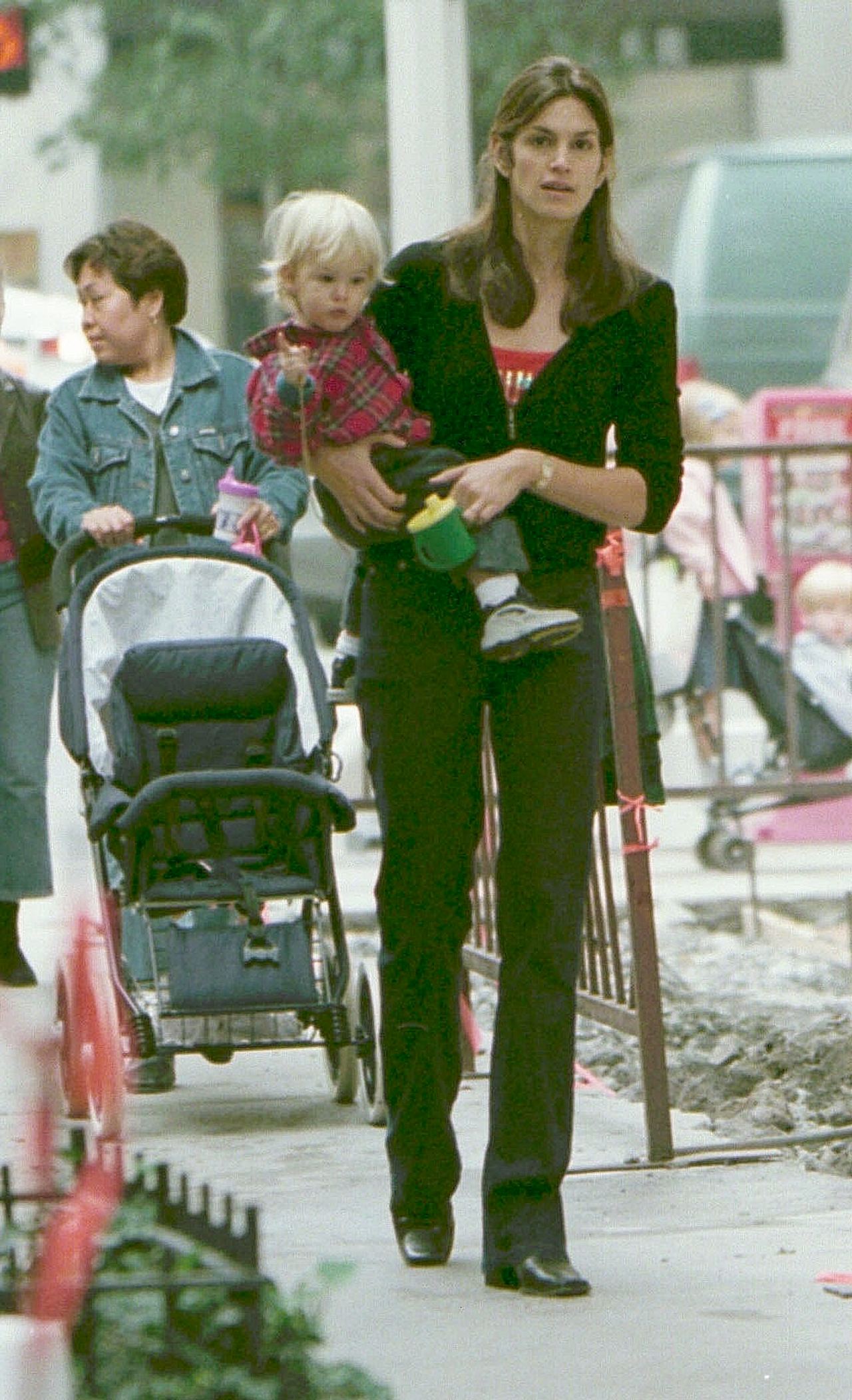 Cindy Crawford carries her young son Presley Gerber while out together in 2000, offering a glimpse of the model as a child long before he would follow his mother into the spotlight. | Source: Getty Images