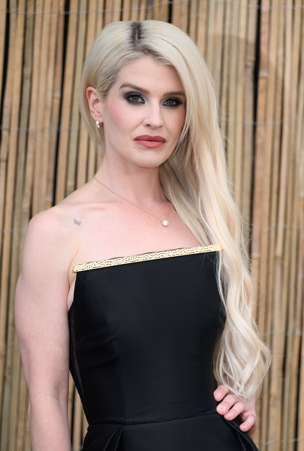 Kelly Osbourne wore her long platinum-blonde hair in loose waves and chose a strapless black dress with gold detailing for London's Serpentine Gallery Summer Party in June 2025, less than a month before her father's death. | Source: Getty Images.