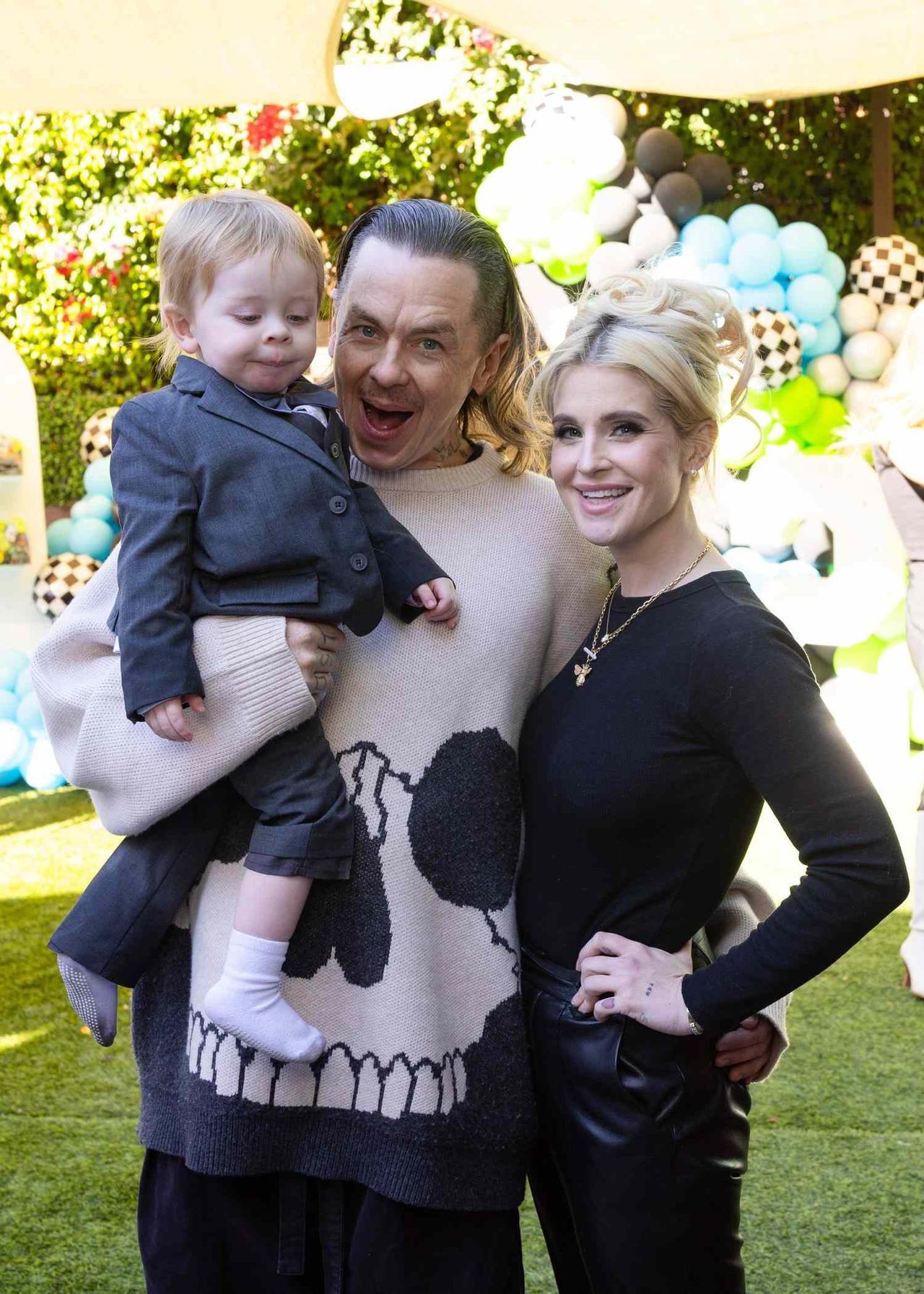 Kelly Osbourne and Sid Wilson shared a happy family moment with their son Sidney at an outdoor celebration, posing together before the couple's engagement came to an end. | Source: Getty Images