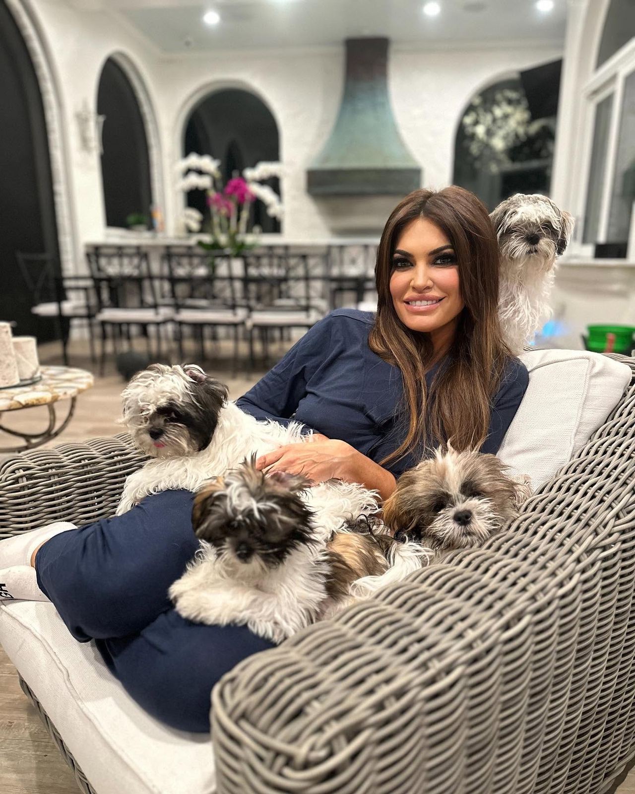 Away from her diplomatic duties, Kimberly Guilfoyle shared a glimpse of her personal life, relaxing at home surrounded by four small dogs. | Source: Facebook / Kimberly Guilfoyle.