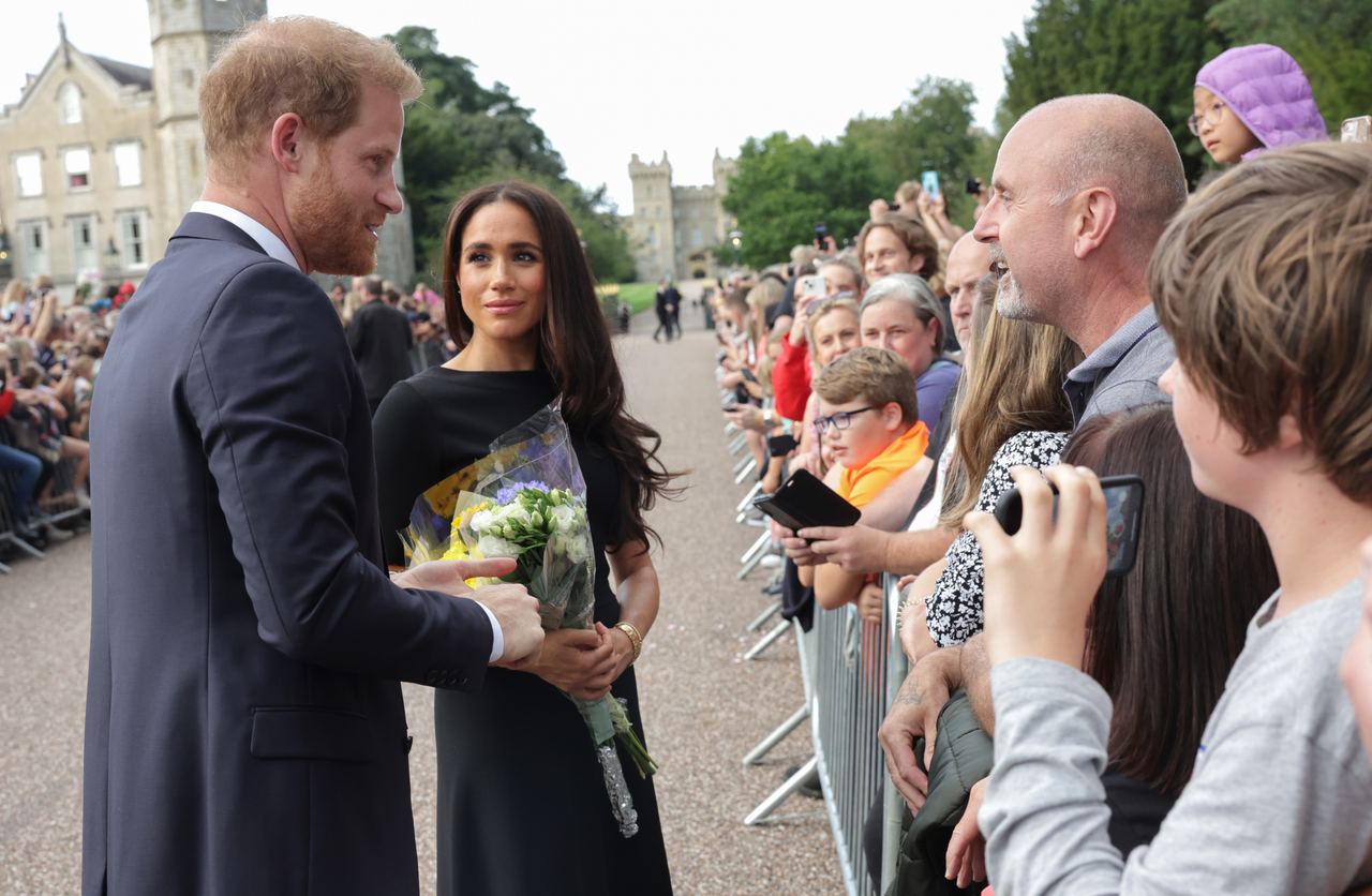 Prince Harry and Meghan, Duchess of Sussex, meet members of the public during an earlier engagement. Harry has since described how years of emotional numbness and stress affected him. | Source: Getty Images