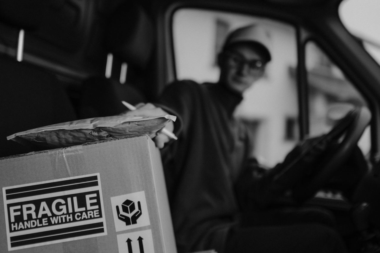 Delivery driver handling a package | Source: Pexels