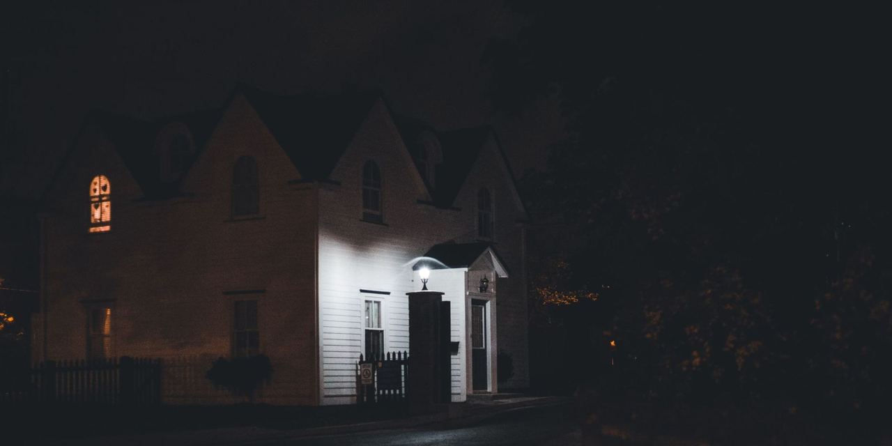 A quiet night scene of a house softly lit by outside lights | Source: Pexels