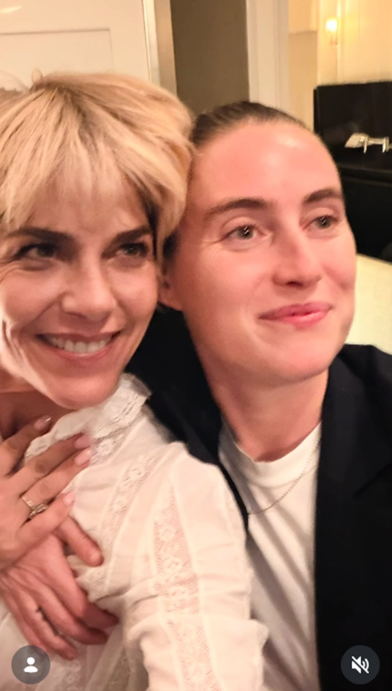 Selma Blair and a companion smile warmly side by side in a close indoor portrait on October 11, 2026. Blair models an intricate sheer ivory lace blouse with delicate embroidery, resting one hand over her chest as they lean together. | Source: Instagram/selmablair