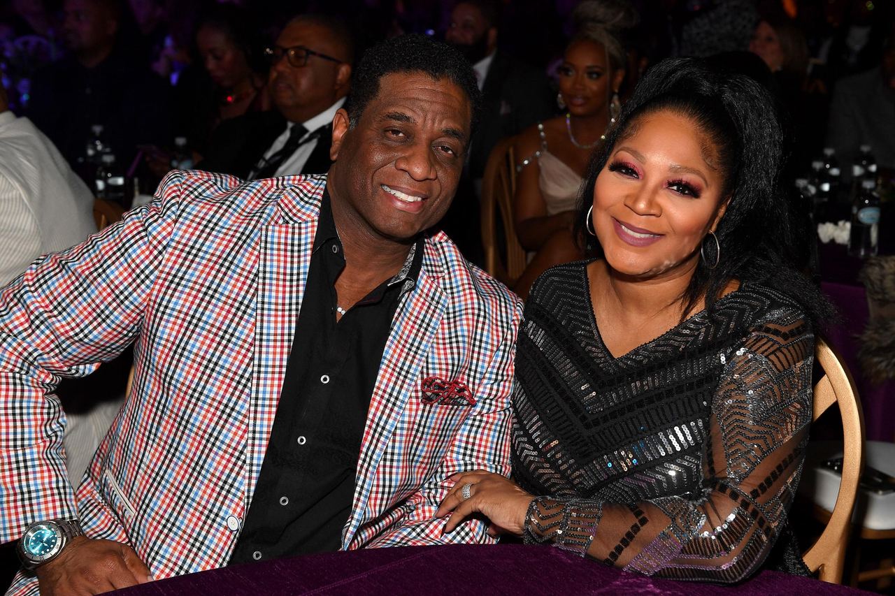Von Scales and singer Trina Braxton smiled warmly while seated together at The 6th Annual URBAN ONE HONORS: Best In Black presented by TV One at the Coca-Cola Roxy on January 20, 2024, in Atlanta, Georgia. Scales stood out in an eye-catching red, black, and white plaid blazer paired with a black dress shirt, while Braxton dazzled beside him in a glittering, chevron-sequined black gown with sheer long sleeves, accessorized with hoop earrings and a high ponytail. | Source: Getty Images