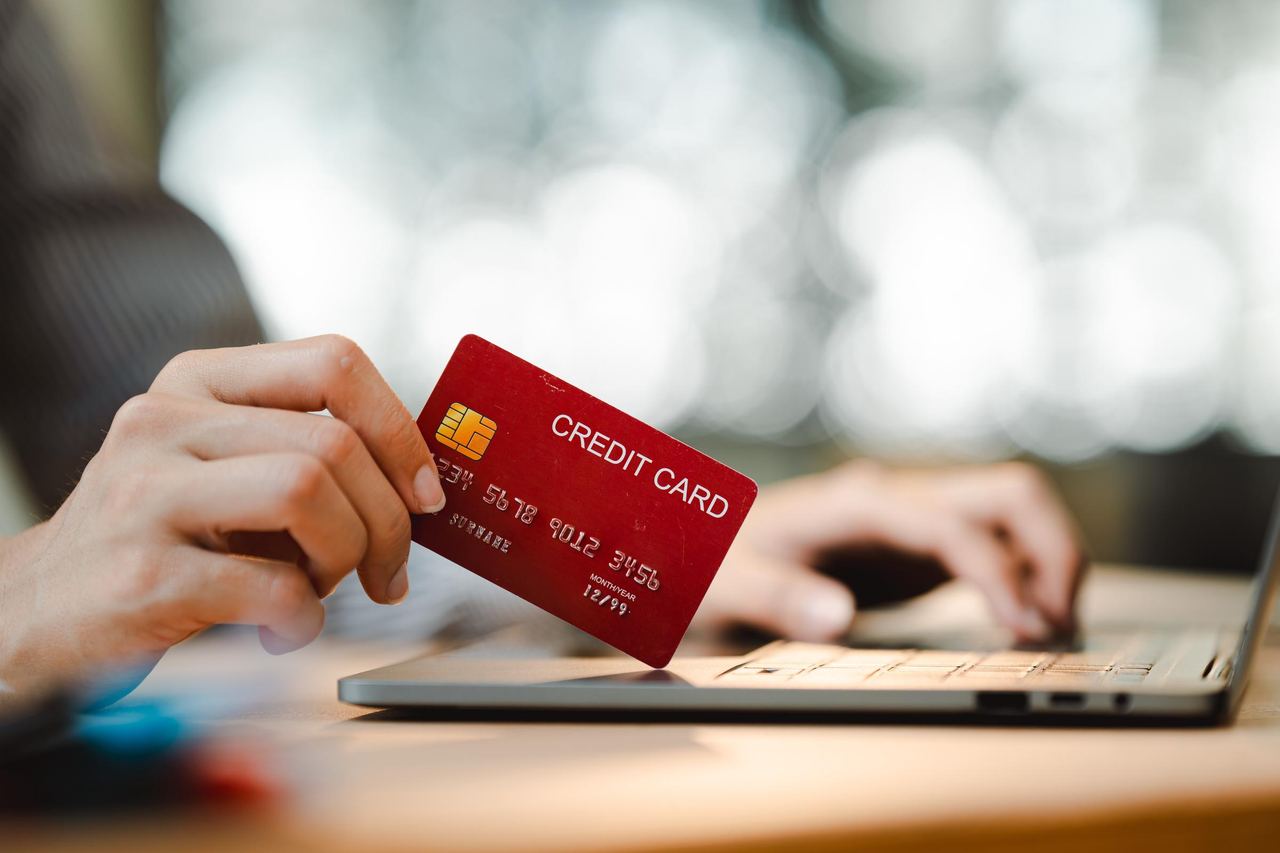 A person keying credit card information on a laptop | Source: Shutterstock