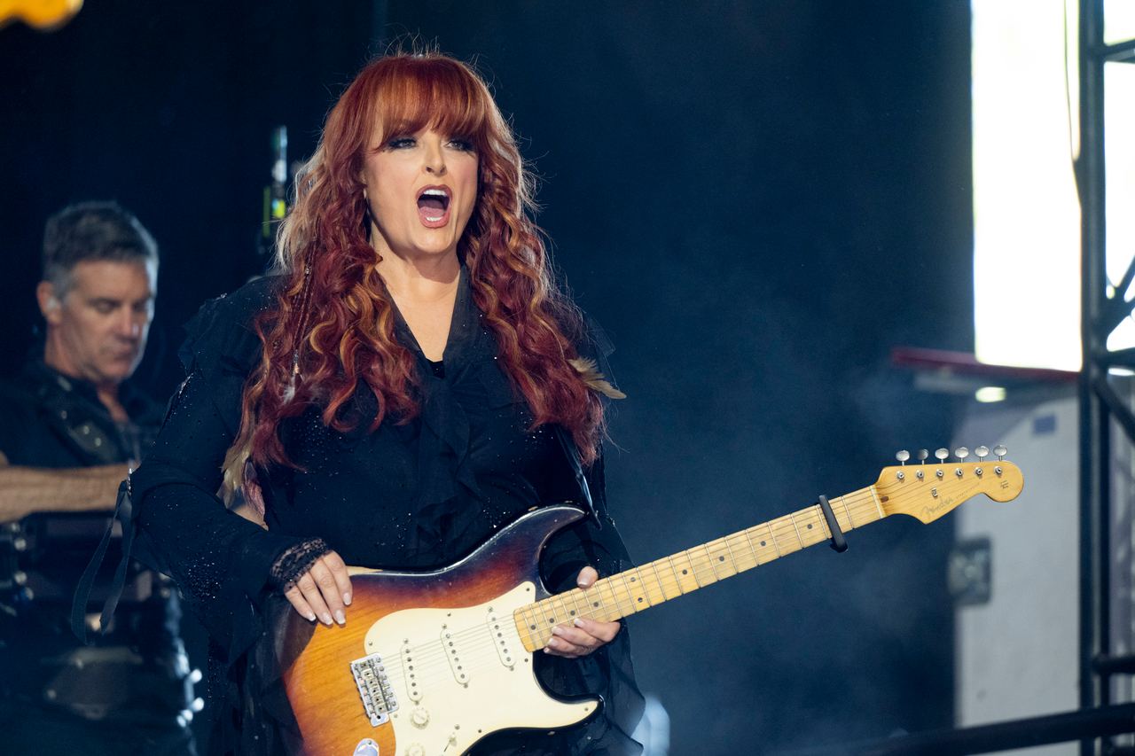 Wynonna Judd performs at the Stagecoach Festival in Indio, California, on April 24, 2026, holding an electric guitar onstage. The appearance captures the performing side of her life, which contrasts with the quieter moments documented in photographs of her Tennessee home. | Source: Getty Images
